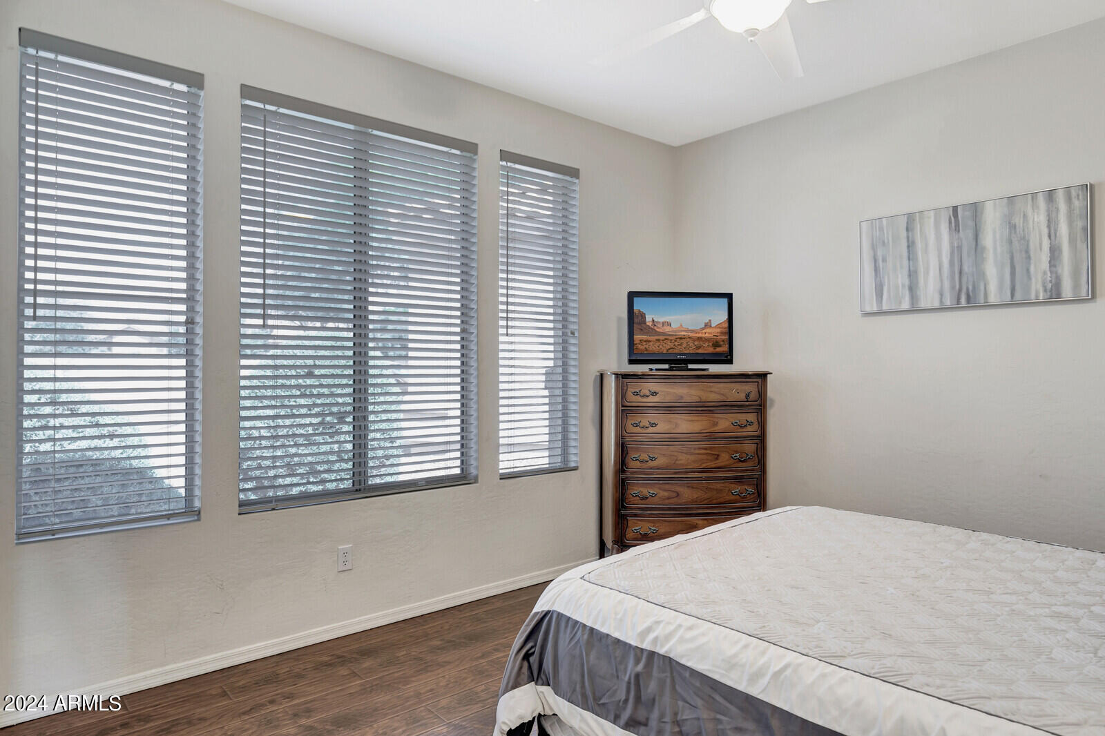 4343 East Mossman Drive Phoenix, AZ 85050 - Photo 22 of 36 a bedroom with a bed and wooden floor