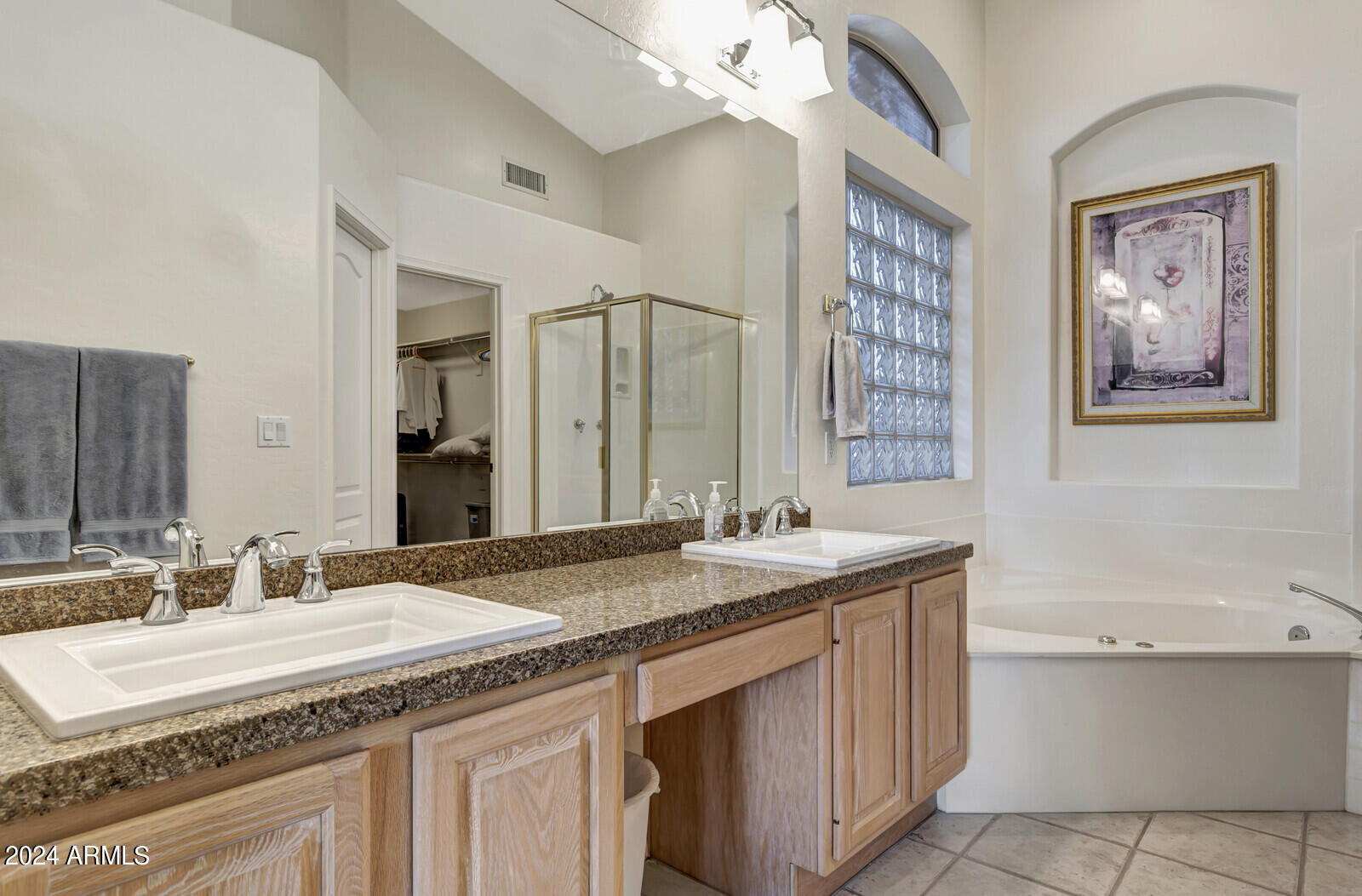 4343 East Mossman Drive Phoenix, AZ 85050 - Photo 26 of 36 a bathroom with a granite countertop sink a large mirror and a bathtub