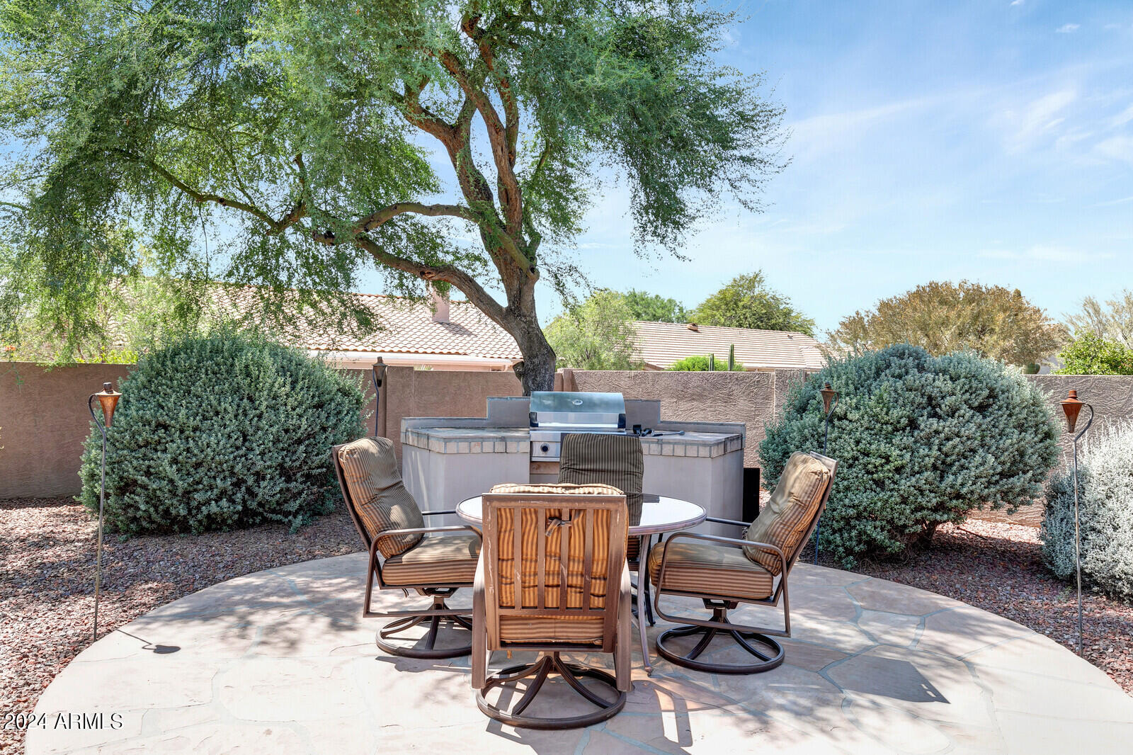 4343 East Mossman Drive Phoenix, AZ 85050 - Photo 33 of 36 a view of a chairs and table in backyard