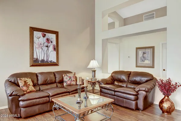 a kitchen with kitchen island granite countertop a sink a stove a dining table and chairs