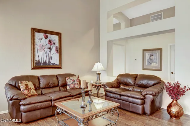 a kitchen with kitchen island granite countertop a sink a stove a dining table and chairs