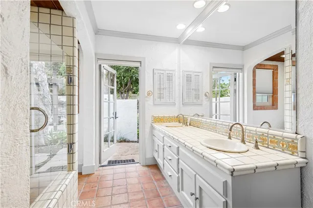 a spacious bathroom with a granite countertop sink and a mirror