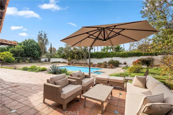a view of a patio with couches under an umbrella