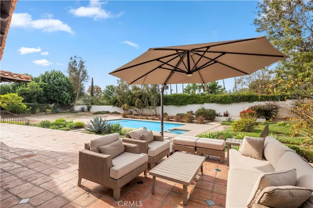 a view of a patio with couches under an umbrella