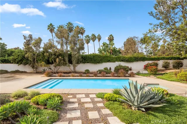 a view of a swimming pool and lounge chair