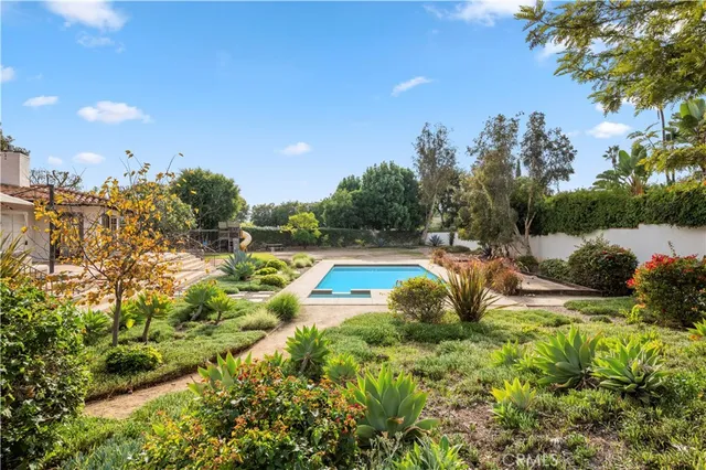 a view of a swimming pool with an outdoor space and seating area