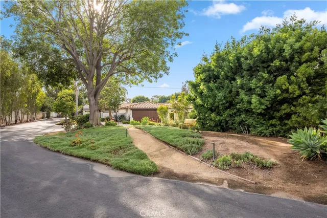 a front view of a house with a yard and fountain