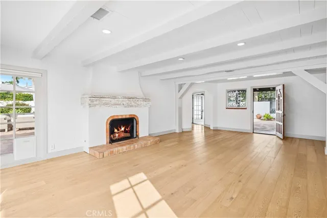a view of a livingroom with a fireplace a fireplace and windows