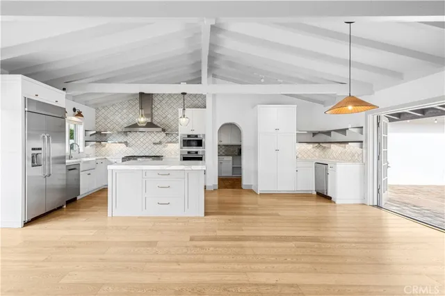 a kitchen with stainless steel appliances kitchen island a refrigerator and a stove