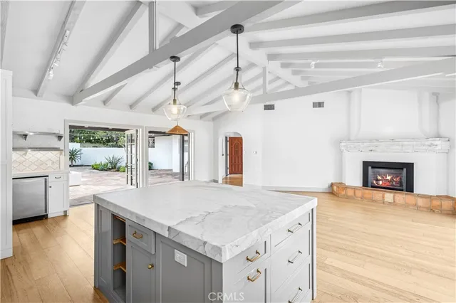 a view of a kitchen with a sink and a fireplace