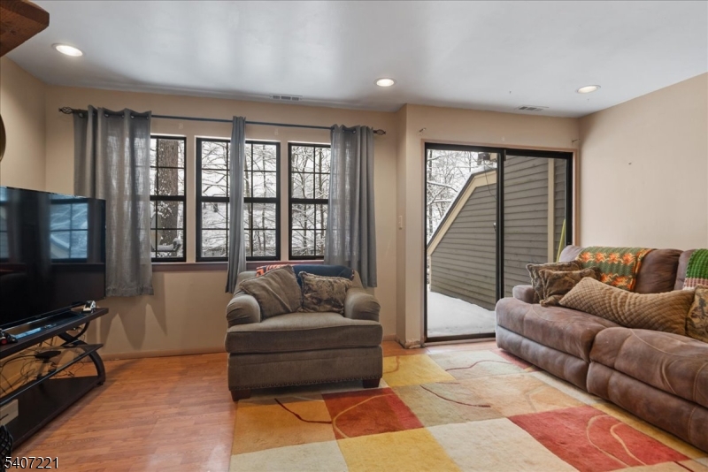 33 Concord Road, Unit D West Milford, NJ 07480 - Photo 16 of 39 a living room with furniture and a flat screen tv