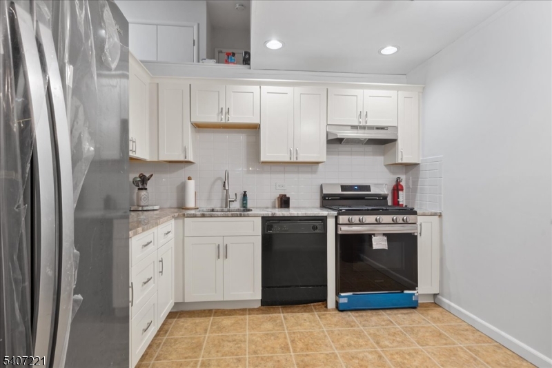 33 Concord Road, Unit D West Milford, NJ 07480 - Photo 22 of 39 a kitchen with stainless steel appliances granite countertop a stove a sink and a refrigerator