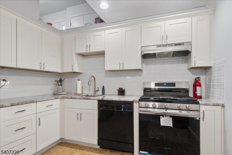 33 Concord Road, Unit D West Milford, NJ 07480 - Photo 24 of 39 a kitchen with stainless steel appliances granite countertop a sink stove and cabinets