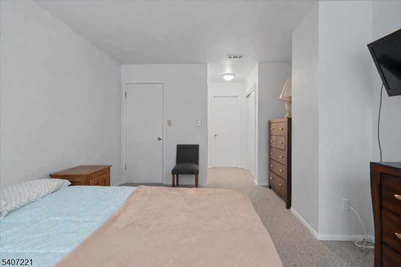 33 Concord Road, Unit D West Milford, NJ 07480 - Photo 30 of 39 a bedroom with a bed and a flat screen tv