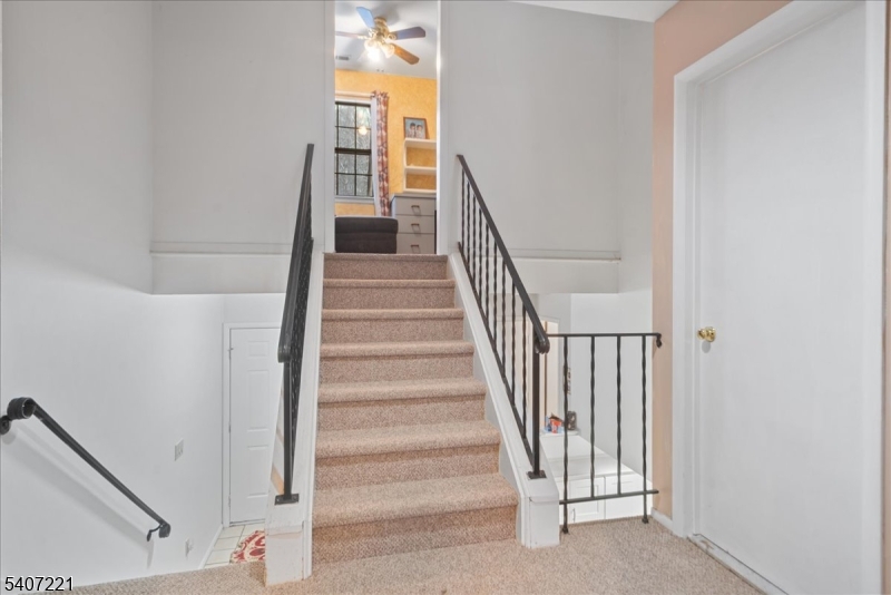 33 Concord Road, Unit D West Milford, NJ 07480 - Photo 33 of 39 a view of staircase with wooden floor and white walls