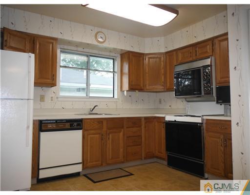 804 Pompton Road Monroe Township, NJ 08831 - Photo 9 of 12 a kitchen with stainless steel appliances granite countertop a sink and a stove