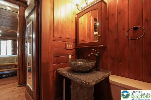 a bathroom with a sink a toilet and a window