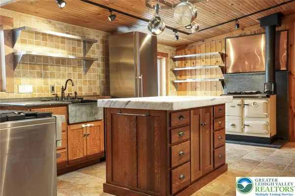 a large kitchen with stainless steel appliances and a stove