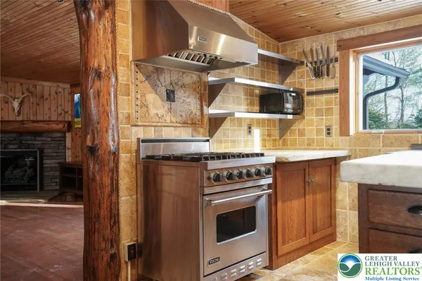a kitchen with kitchen island granite countertop a sink and wooden cabinets