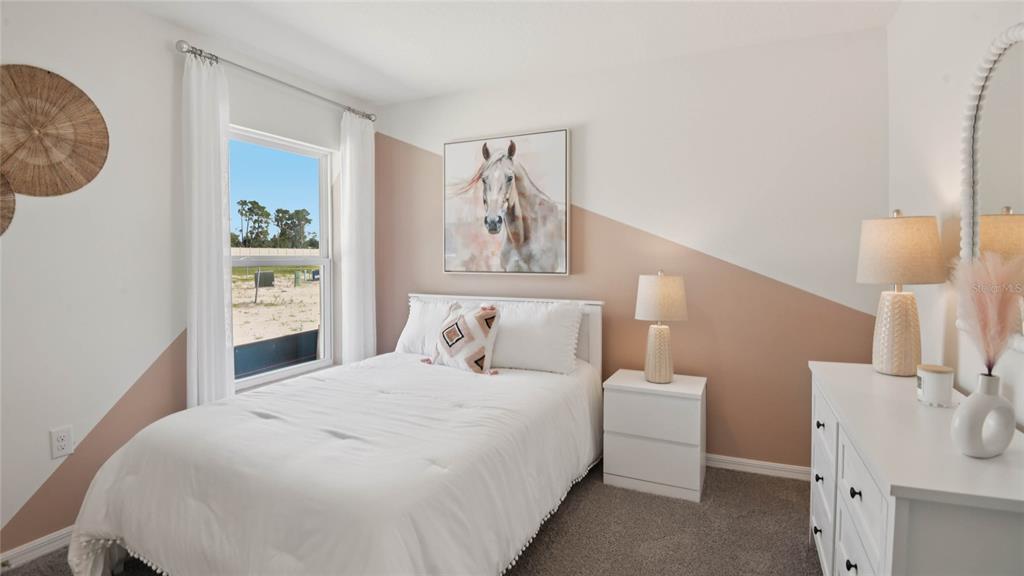 24495 Northwest 10th Road Newberry, FL 32669 - Photo 15 of 20 a bedroom with a bed and a lamp