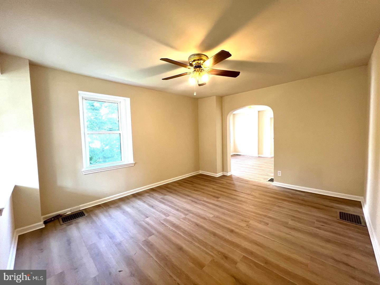617 3rd Street Beverly, NJ 08010 - Photo 2 of 17 a view of an empty room with window and wooden floor