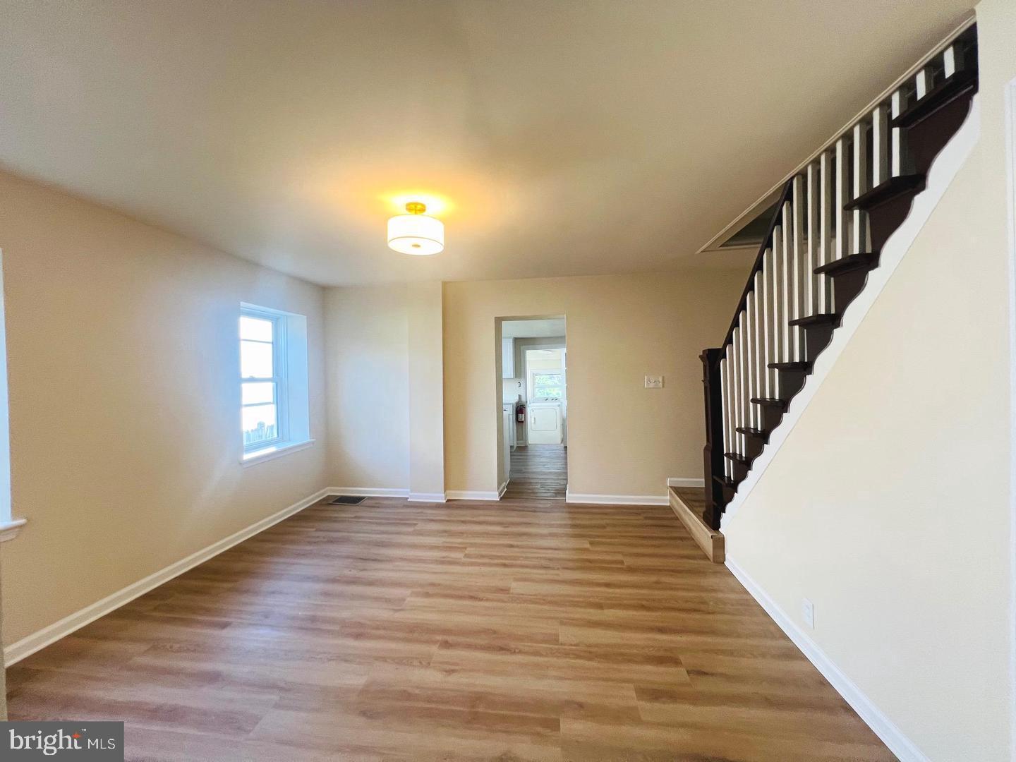 617 3rd Street Beverly, NJ 08010 - Photo 4 of 17 a view of empty room with wooden floor and fan