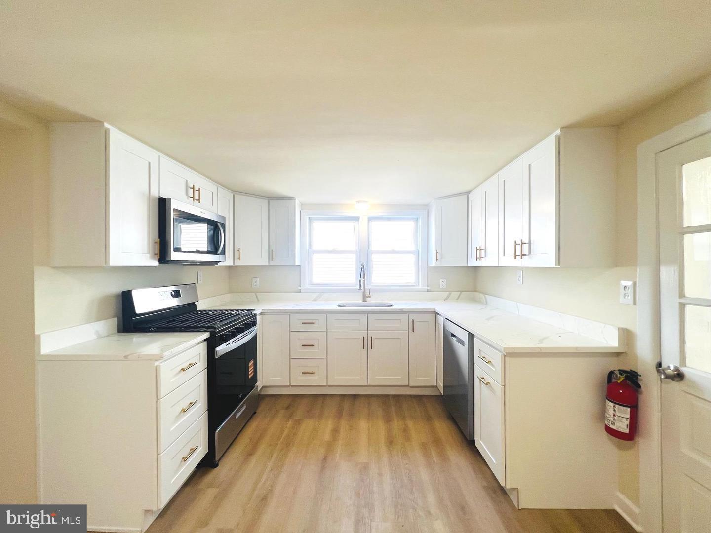 617 3rd Street Beverly, NJ 08010 - Photo 8 of 17 a kitchen with granite countertop appliances cabinets and a sink