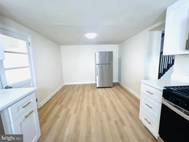 a view of kitchen and wooden floor