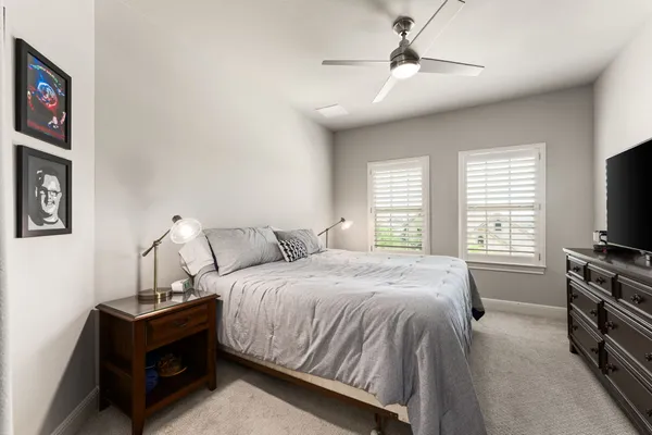 a bedroom with a bed and a tv on the dresser