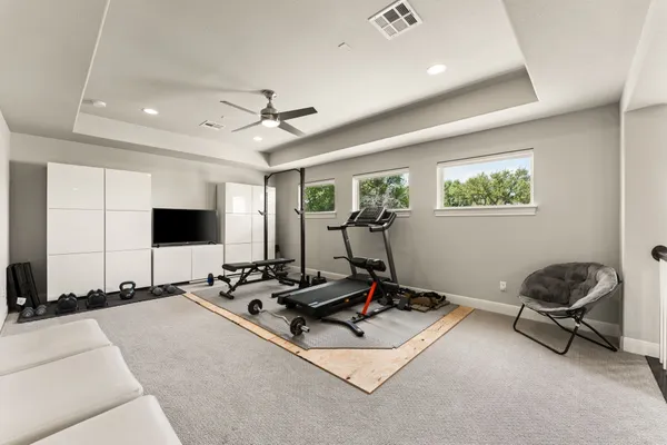 a room with gym equipment and windows