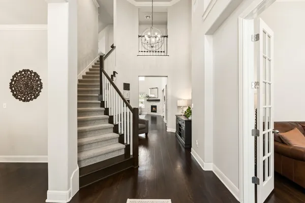 a view of a hallway with wooden floor and entryway