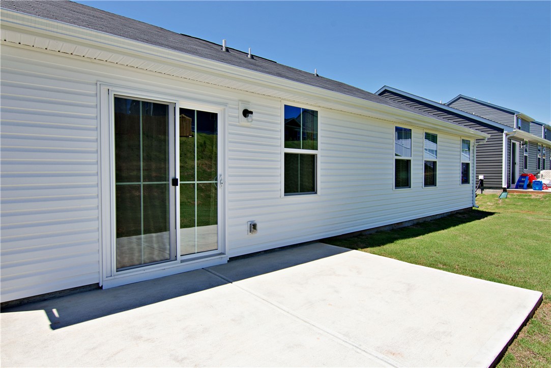 723 Peridot Way Westminster, SC 29693 - Photo 33 of 45 A spacious concrete patio awaits outdoor enjoyment, seamlessly connecting to the home via sliding glass doors.