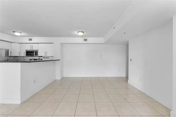 a view of kitchen with white cabinets