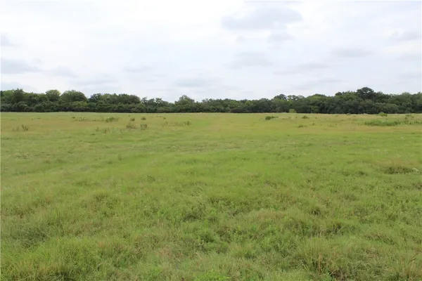 a view of a lake with houses in the back