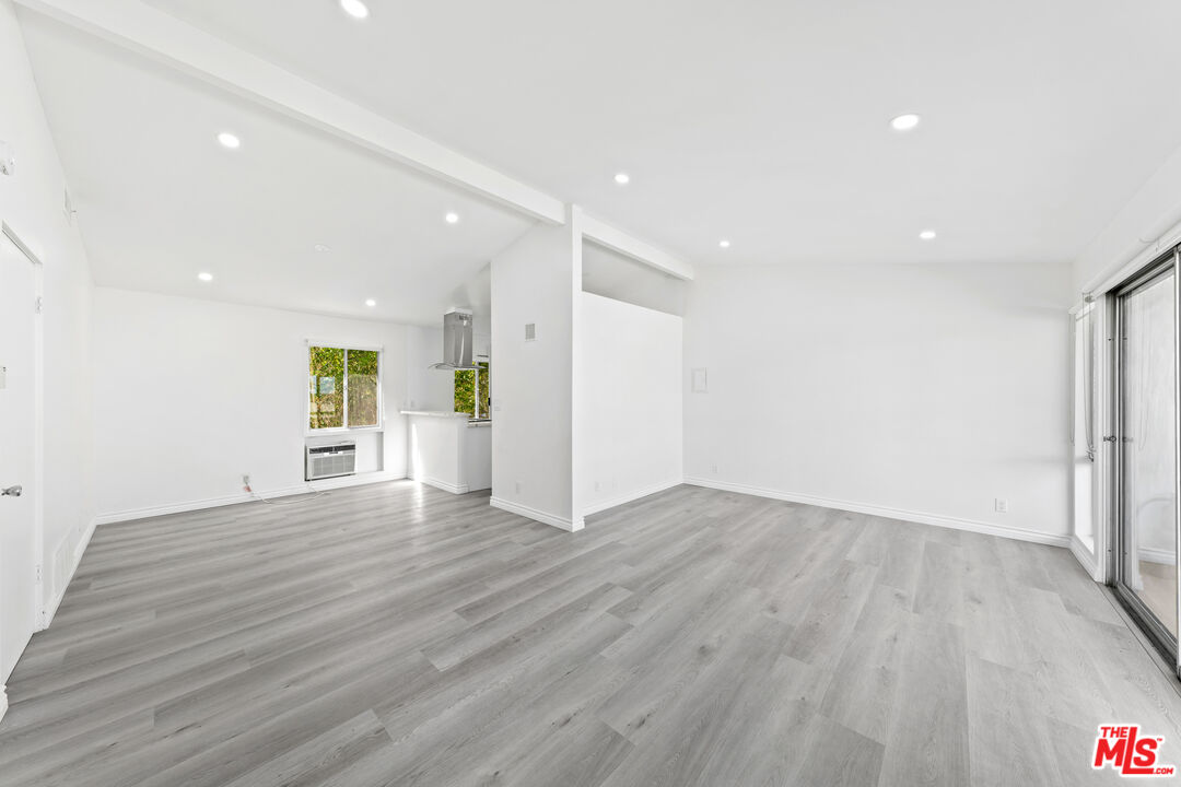 825 16th Street, Unit B Santa Monica, CA 90403 - Photo 12 of 15 a view of an empty room with wooden floor and a window