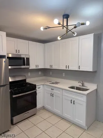 a kitchen with cabinets appliances and a sink