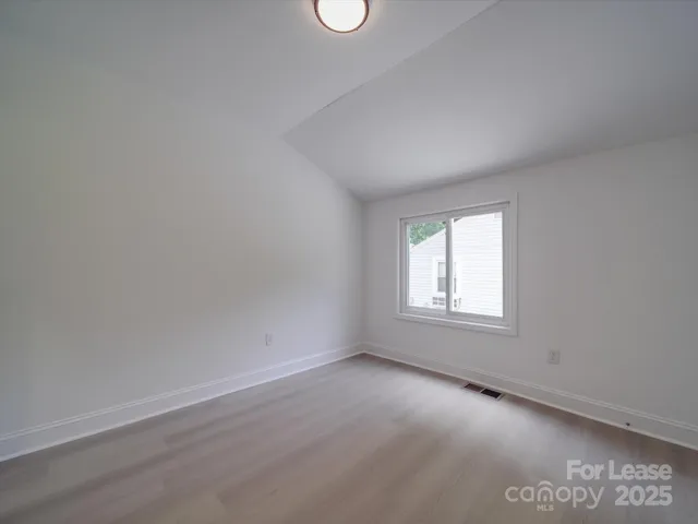 an empty room with a empty space and windows