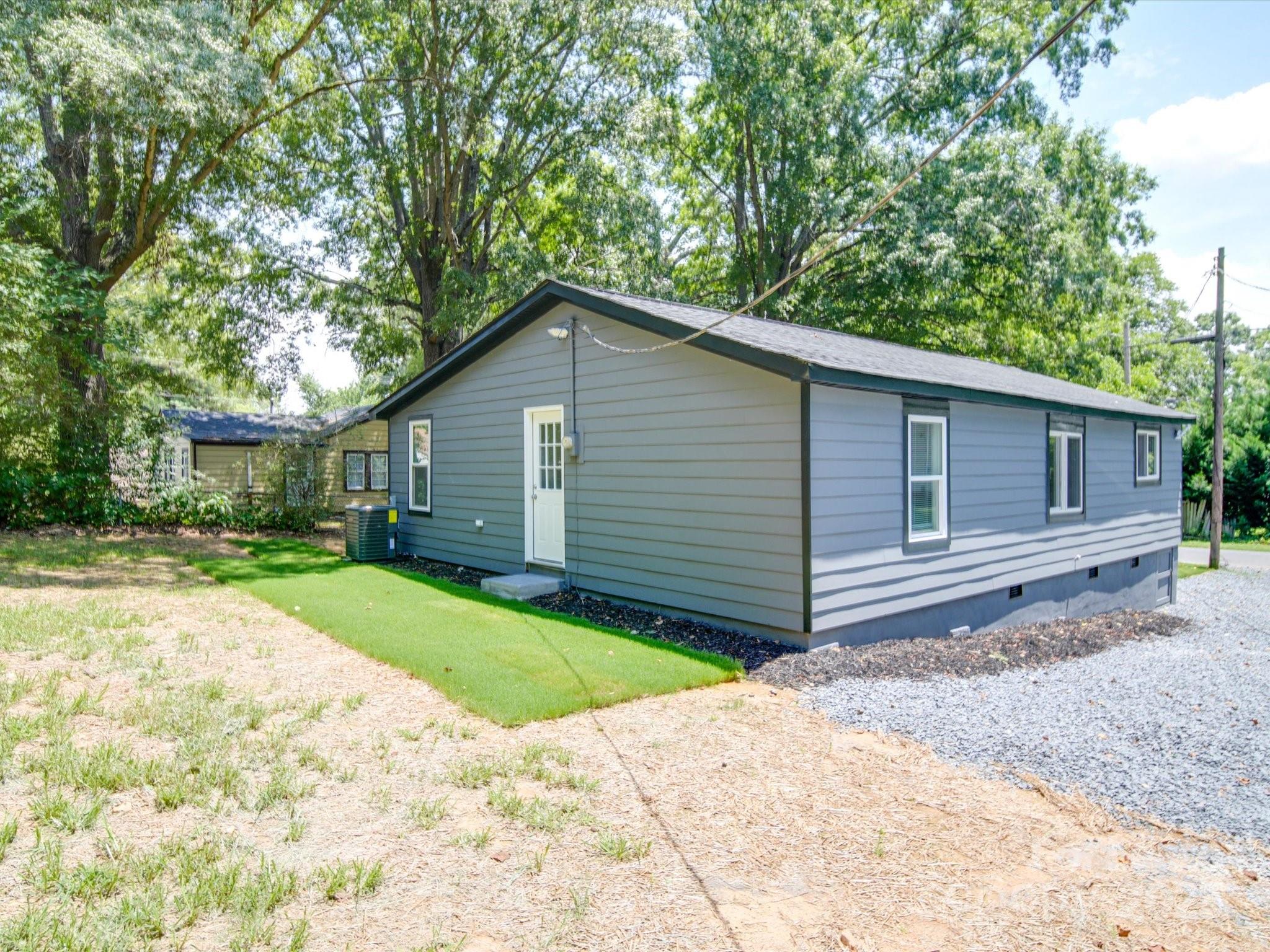 1012 Wood Street Albemarle, NC 28001 - Photo 2 of 31 a front view of house with yard and trees in the background