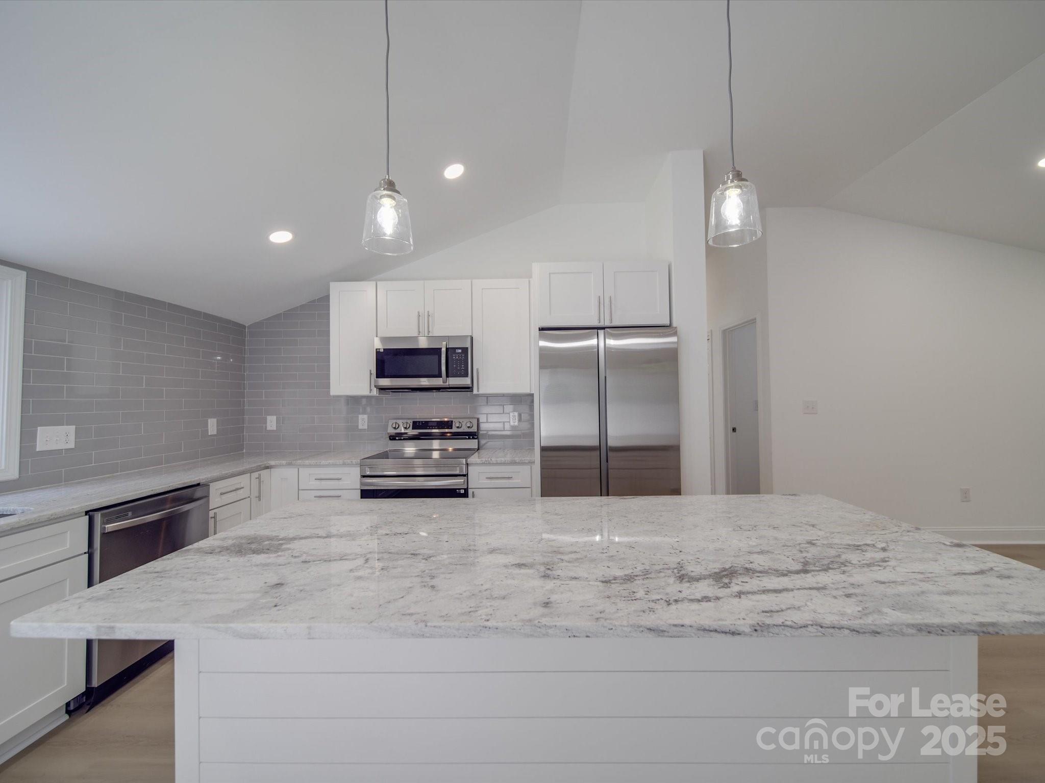 1012 Wood Street Albemarle, NC 28001 - Photo 22 of 31 a kitchen with stainless steel appliances kitchen island granite countertop a stove a refrigerator and a sink