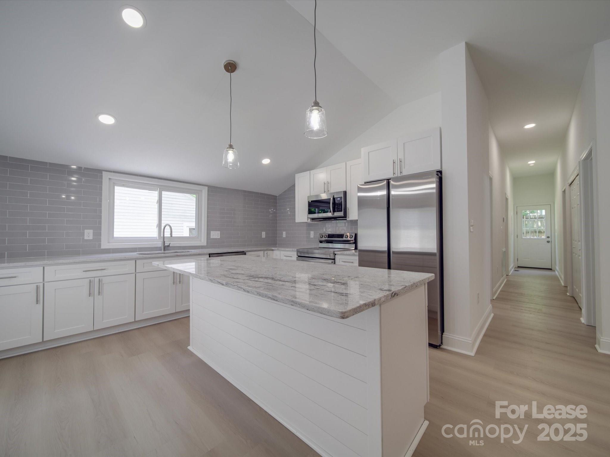 1012 Wood Street Albemarle, NC 28001 - Photo 23 of 31 a large kitchen with a large counter top a sink stainless steel appliances and cabinets