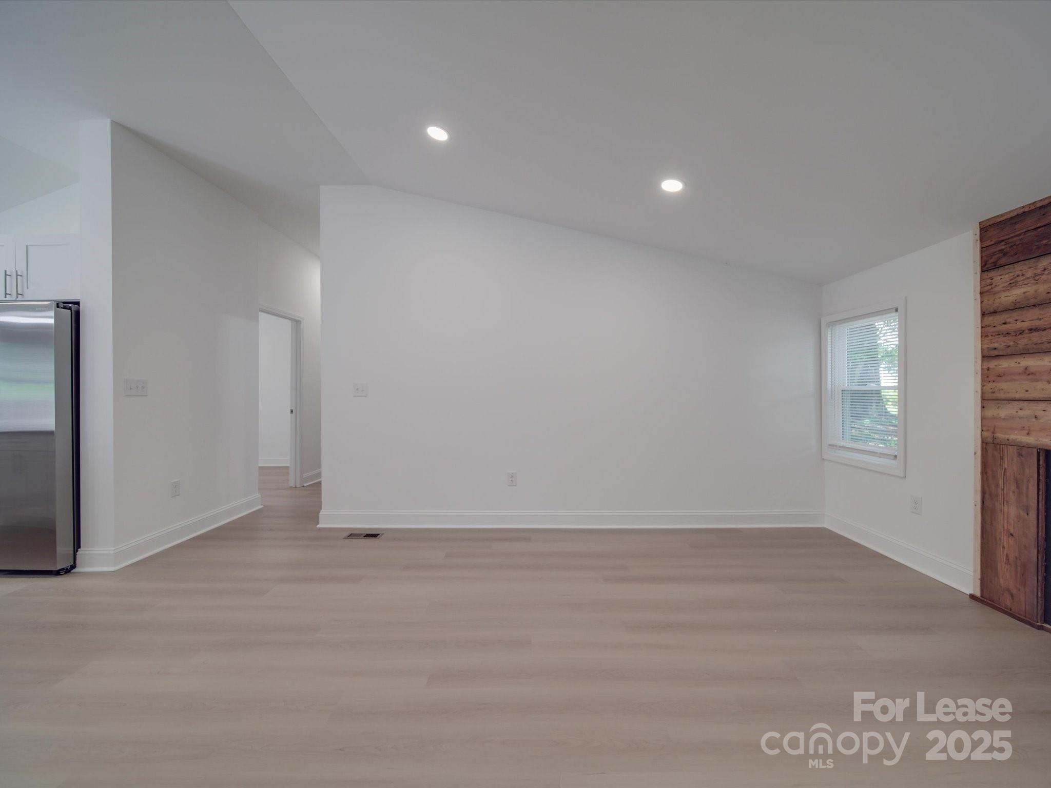 1012 Wood Street Albemarle, NC 28001 - Photo 25 of 31 an empty room with wooden floor and windows