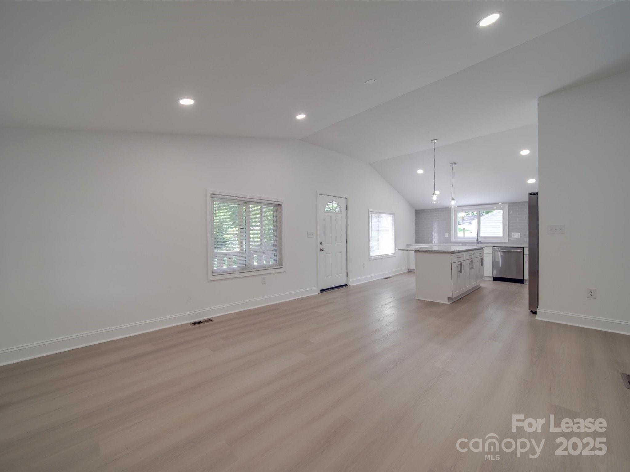 1012 Wood Street Albemarle, NC 28001 - Photo 27 of 31 an empty room with wooden floor and windows