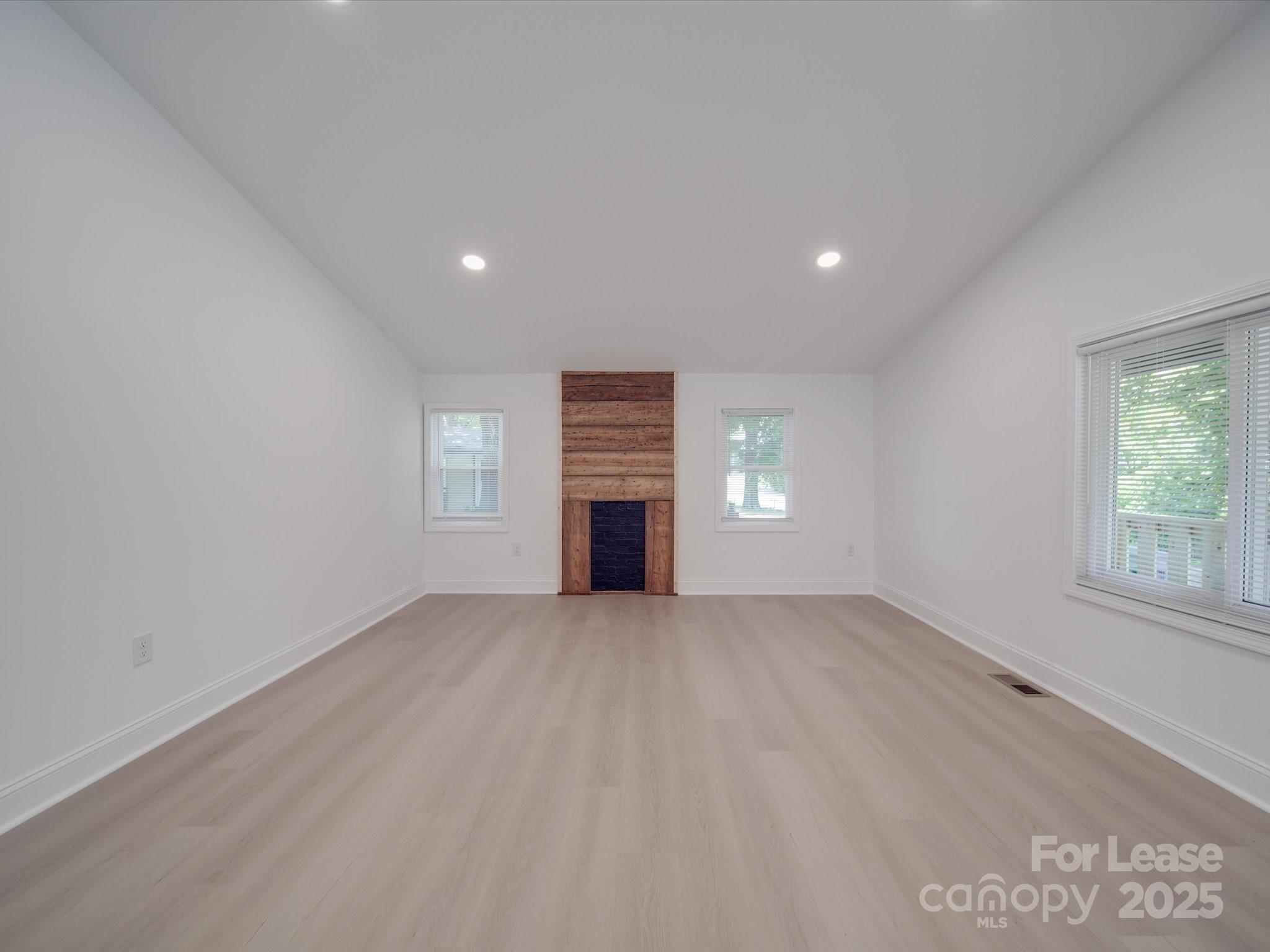 1012 Wood Street Albemarle, NC 28001 - Photo 29 of 31 an empty room with windows and fireplace