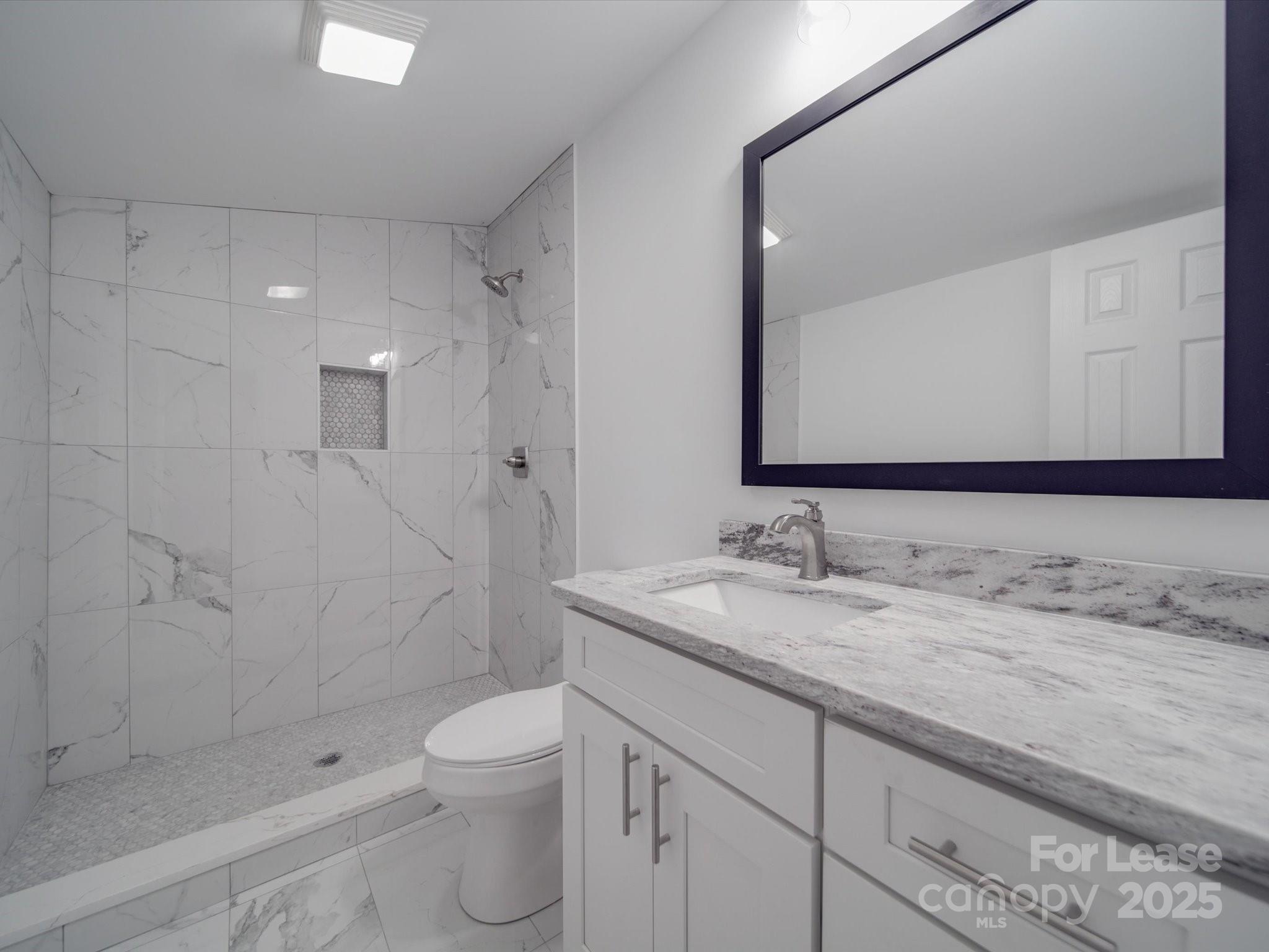 1012 Wood Street Albemarle, NC 28001 - Photo 8 of 31 a bathroom with a granite countertop sink a toilet and shower