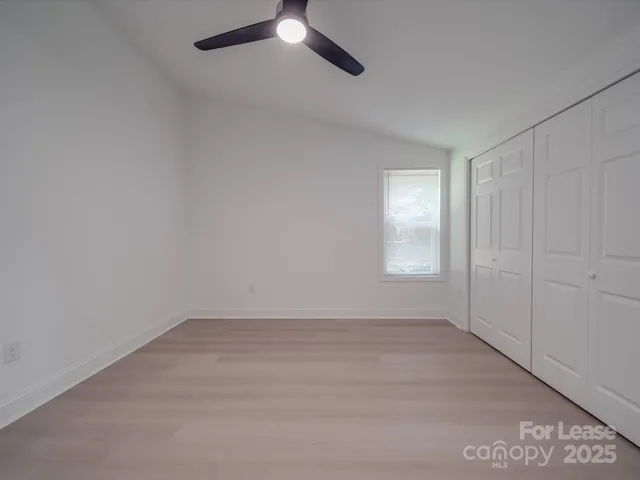 an empty room with a empty space and windows