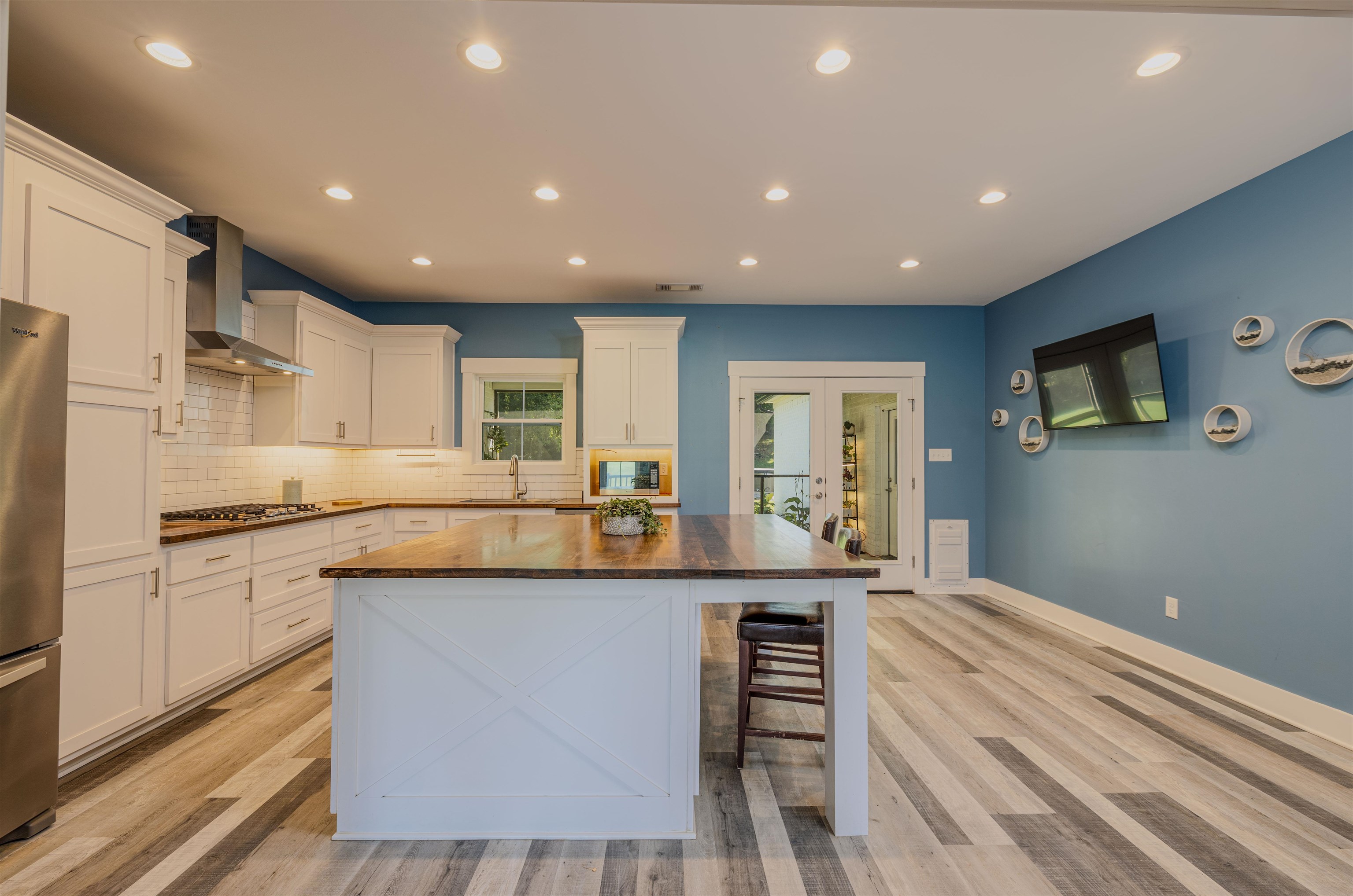 3090 Marshall Road Munford, TN 38058 - Photo 11 of 27 Kitchen featuring recessed lighting, a kitchen bar, white cabinets, french doors, and stainless steel appliances