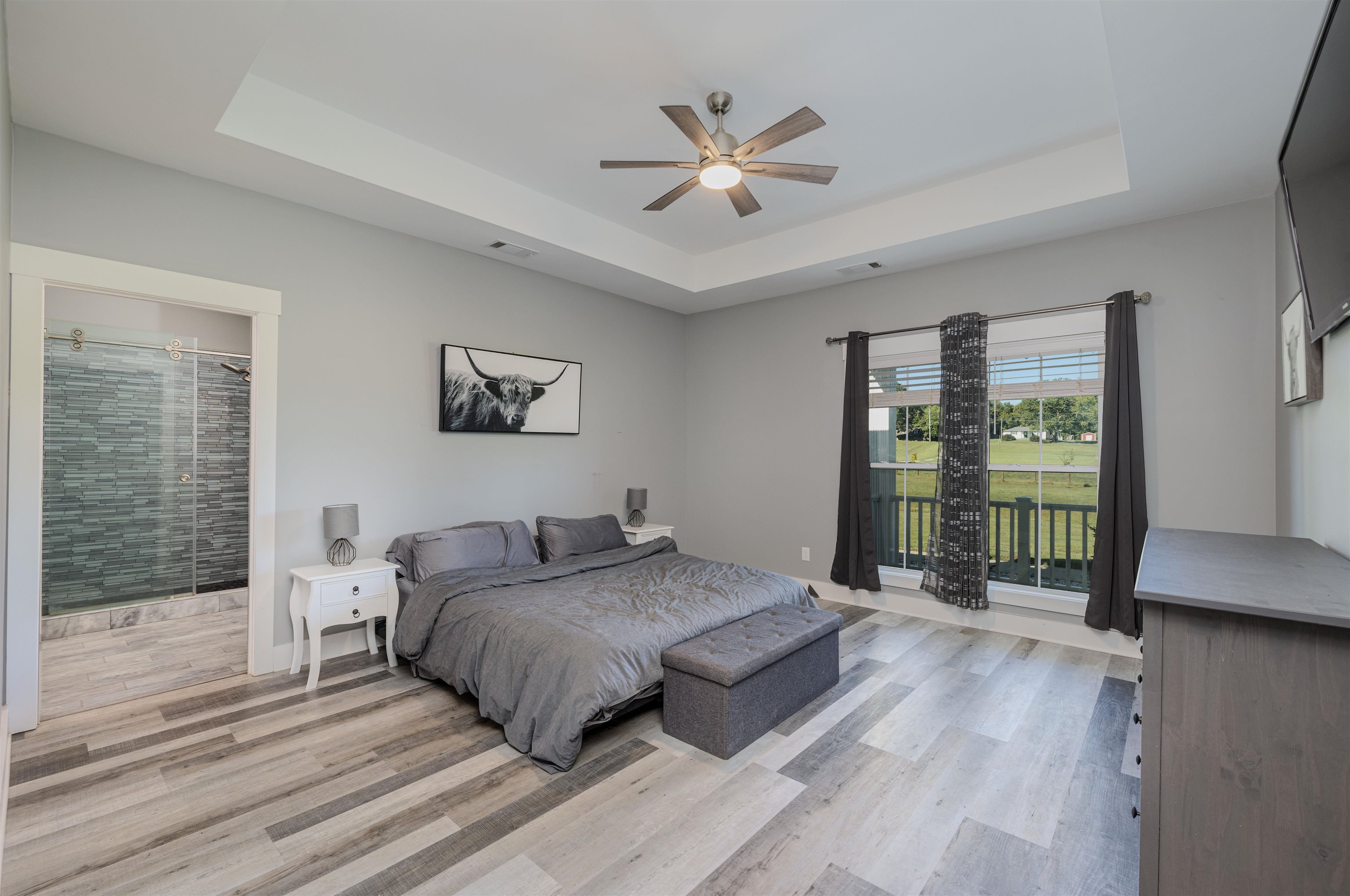 3090 Marshall Road Munford, TN 38058 - Photo 24 of 27 Bedroom with light wood-style flooring, a raised ceiling, ensuite bath, and ceiling fan