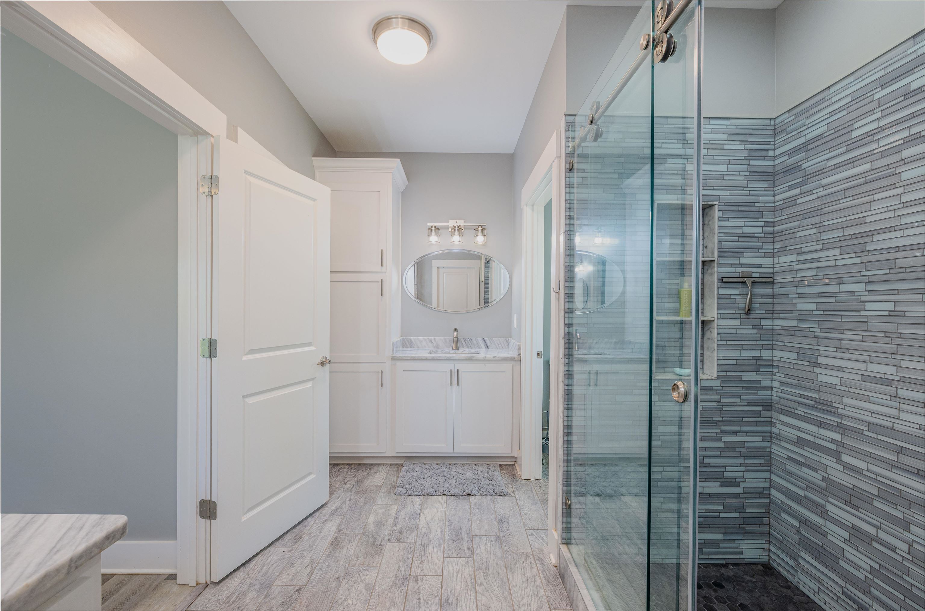 3090 Marshall Road Munford, TN 38058 - Photo 25 of 27 Bathroom featuring vanity, a stall shower, and light wood-style floors