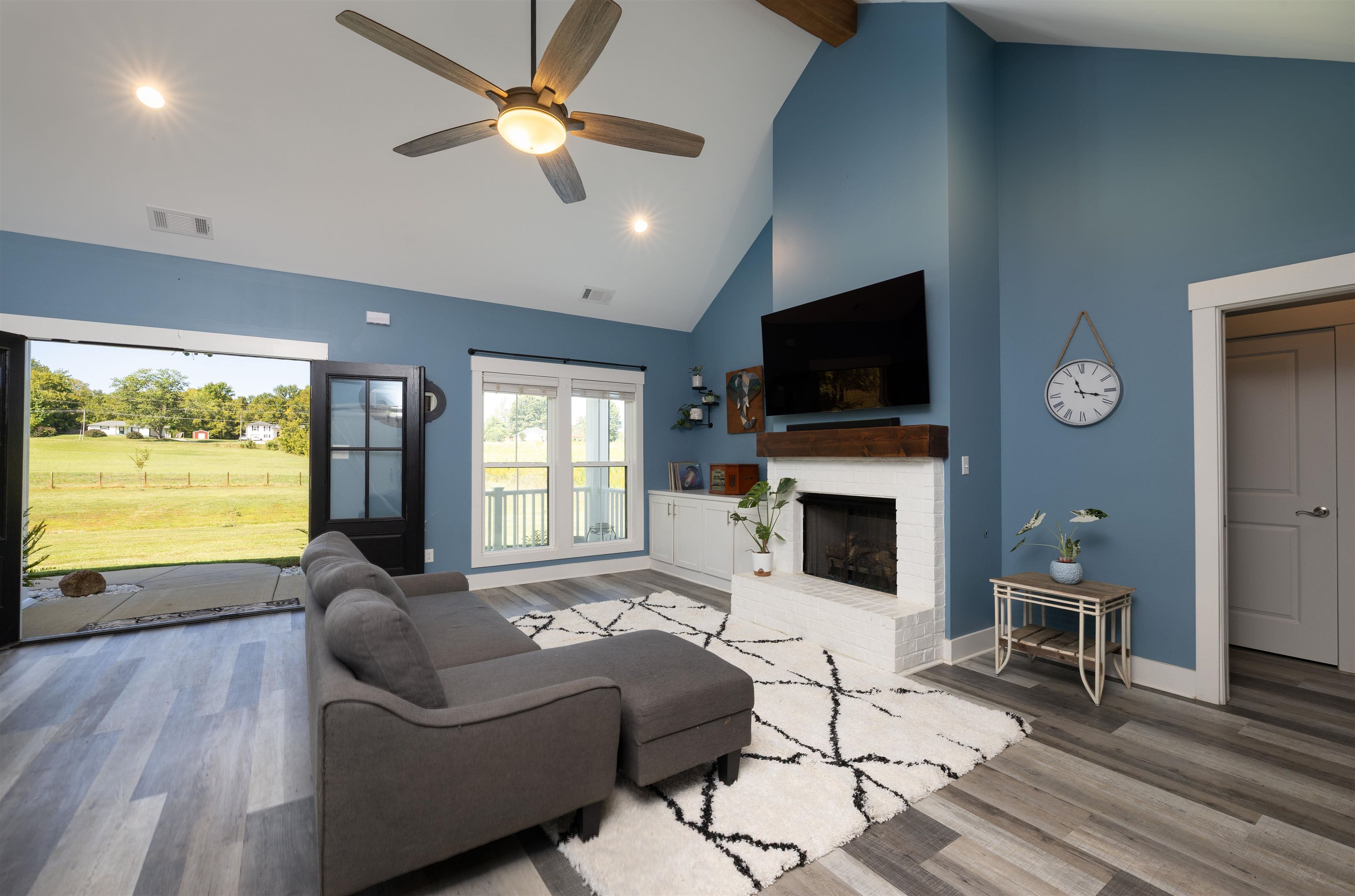 3090 Marshall Road Munford, TN 38058 - Photo 3 of 27 a living room with furniture a fireplace a flat screen tv and a large window