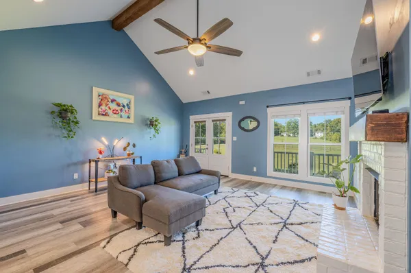 a kitchen with stainless steel appliances granite countertop a kitchen island hardwood floor sink and stove